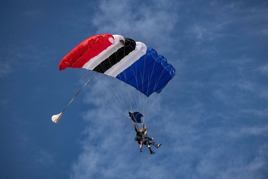 Tandem skydivers under a parachute
