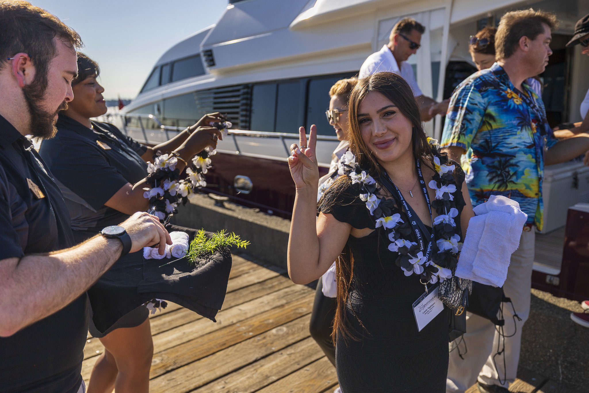 A member greeted with a lei on the dock before a private yacht experience
